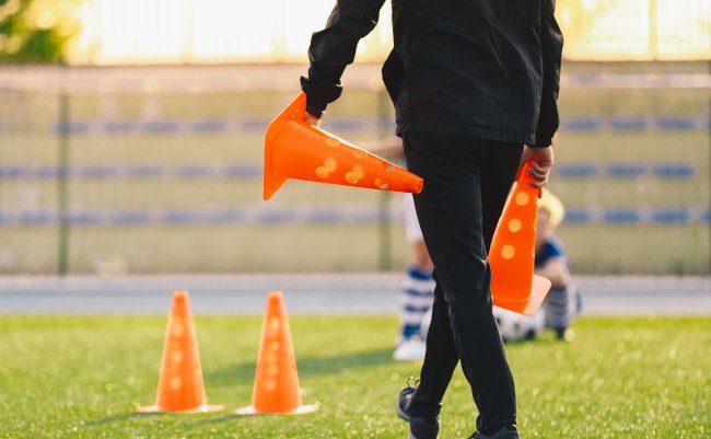 Soccer,Coach,Preparing,Training,Field.,Trainer,Holding,Soccer,Practice,Cones.