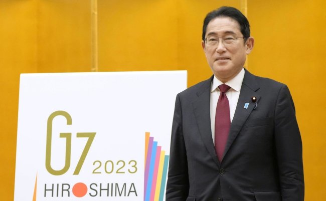 Japanese,Prime,Minister,Fumio,Kishida,Stands,With,The,Logo,For