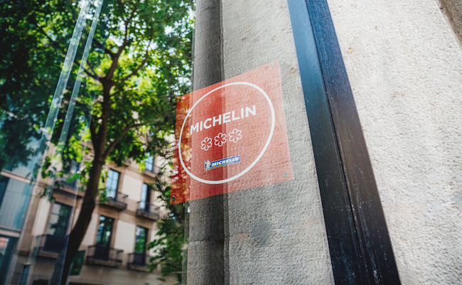 Barcelona, Spain - Jun 1, 2018: View from the street at the interior placed red sign 2017 Michelin three stars in luxury upper scale restaurant exceptional cuisine that is worth a special journey