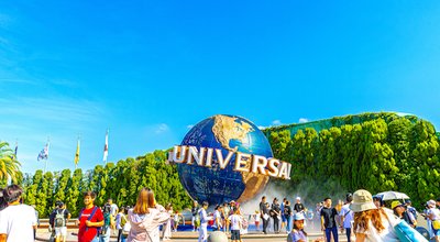 OSAKA, JAPAN - August 10, 2019. Tourists and theme park visitors front of rotating globe fountain in front of Universal Studios. Universal Studios Japan is a fun and famous theme park in Osaka, Japan.