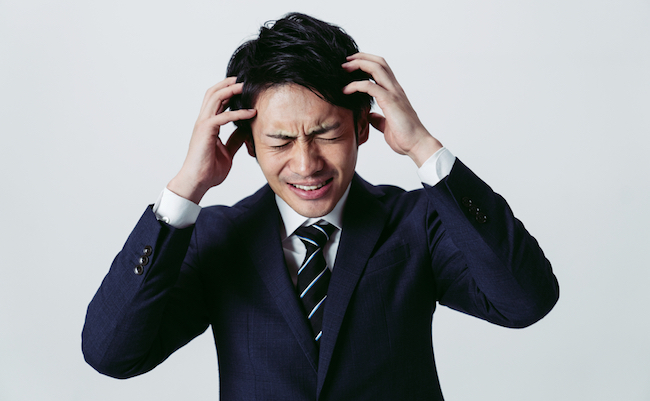 Irritated young asian businessman. Facial expression.