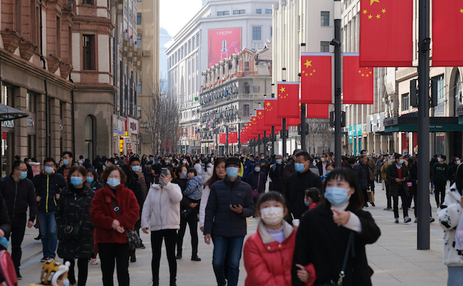 Shanghai.China-Feb.2021: crowded tourists in face mask to prevent covid-19, walking on Nanjing Road
