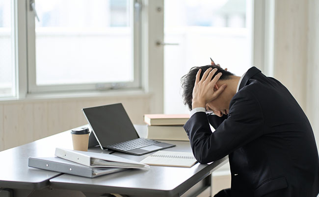 Worried,Asian,Businessman,Holding,His,Head