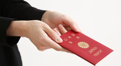 A Japanese passport with the woman's hand