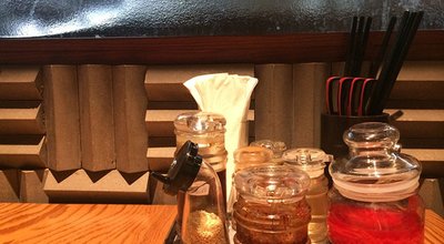 Asian noodle seasoning set sugar, chili, vinegar, ginger, sesame, chili powder, napkin, spoon and chopstick on the pot in the Japaneses Ramen restaurant, Selective focused blur background