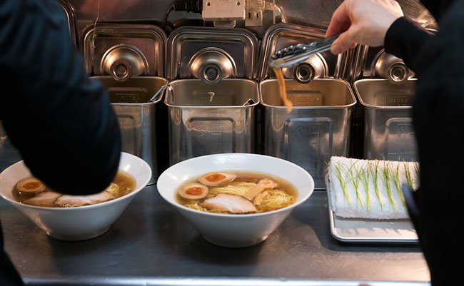 Japanese staff preparing noodles in Tokyo.