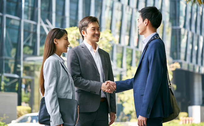 Asian,Business,Associates,Meeting,In,The,Street,In,Downtown,Financial