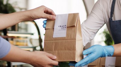 Asia people woman hand glove or face mask happy enjoy buy fast food carry send paper box pick up take home to-go lunch meal. Small cafe coffee shop work with wrap care new normal for SME omni channel.
