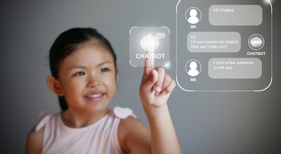 Little girl hand using a digital chatbot program for online chat with human users. Support and customer service automation technology. AI artificial technology for chatterbot or conversational agents