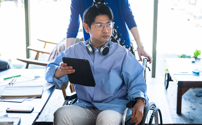 Young,Employee,In,A,Wheelchair,With,Handicap