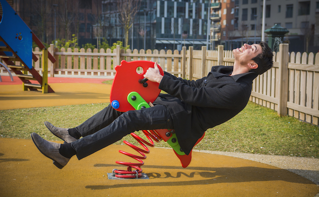 Young,Man,Reliving,His,Childhood,Plying,In,A,Children’s,Playground
