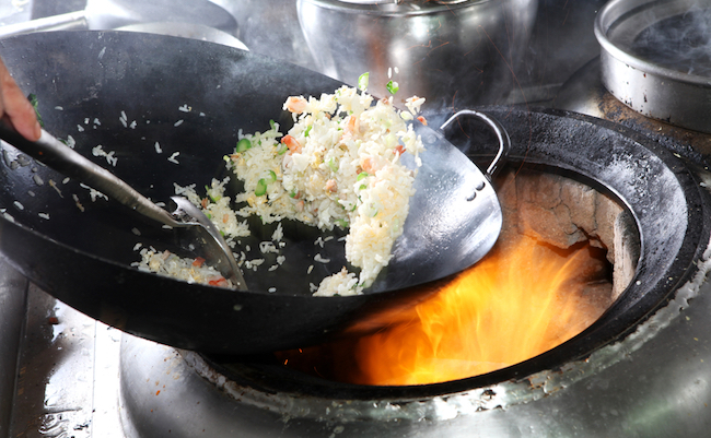 Chef,Cooking,Fried,Rice,With,Flame,In,A,Frying,Pan
