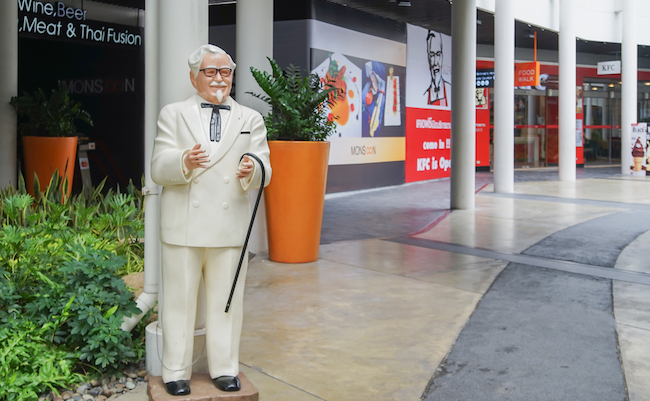 BANGKOK ,THAILAND- May 20 ,2017: Colonel Harland Sanders statue standing in front of Kentacky Fried chicken restaurant (KFC)