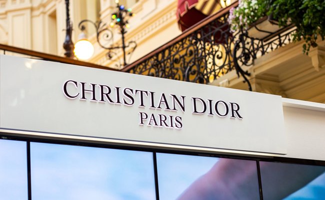 MOSCOW, RUSSIA - AUGUST 10, 2021: Christian Dior Paris brand retail shop logo signboard on the storefront in the shopping mall