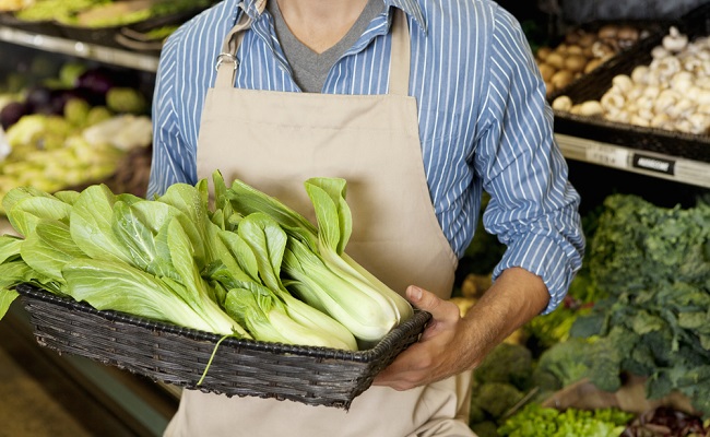 Midsection,Of,Man,Holding,Basket,Of,Bok,Choy,In,Supermarket