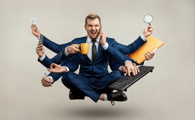 Businessman,With,Many,Hands,In,A,Suit.,Works,Simultaneously,With