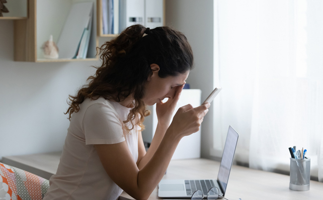 Frustrated,Young,Woman,Feeling,Depressed,,Reading,Message,With,Bad,News