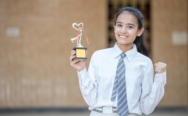 Portrait,Of,A,Happy,School,Girl,With,Prize,In,Hand
