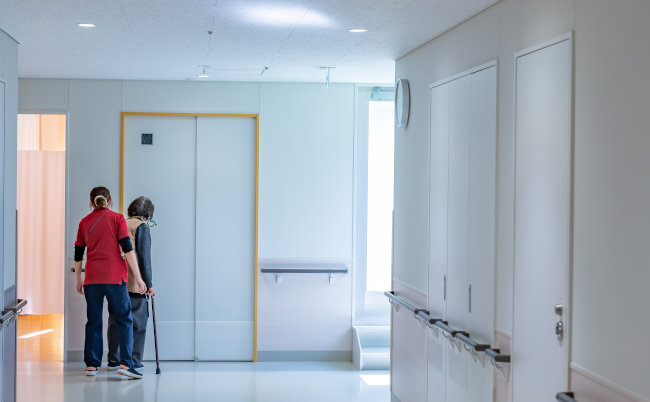 Grandma,Practicing,Walking,With,A,Physiotherapist,Woman