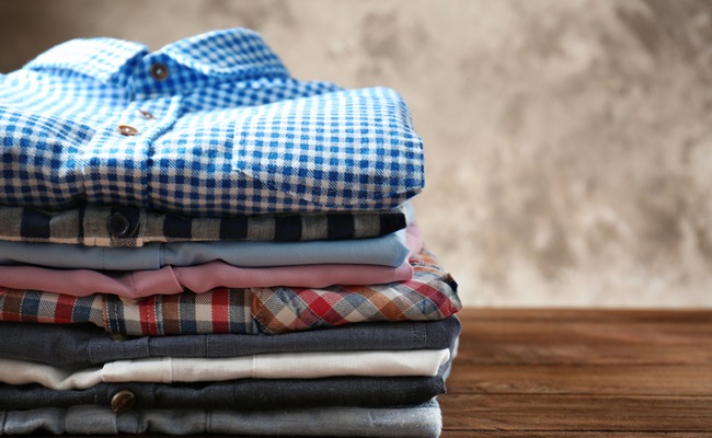 Stack,Of,Colorful,Shirts,On,Table