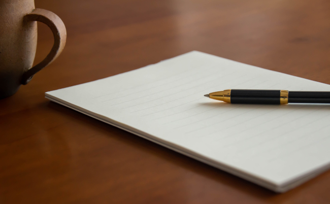 Stationery,,Envelopes,,Ballpoint,Pens,And,Coffee,Placed,On,The,Table