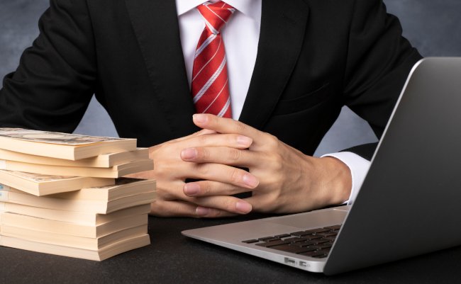 Businessman,With,Bills,And,Computer