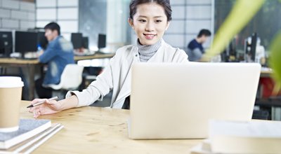 Young,Asian,Business,Woman,Working,In,Office,Using,Laptop,Computer.