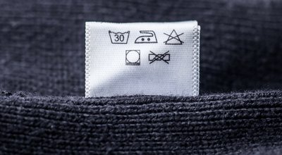 Label,On,Clothes,,Black,Knitted,Sweater.,Delicate,Care.