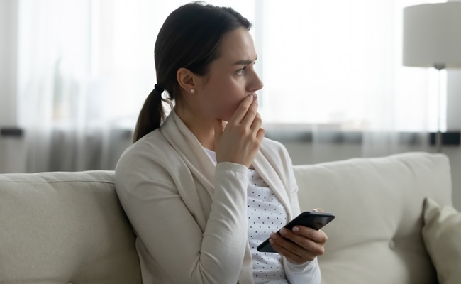 Pensive,Stressed,Young,Caucasian,Woman,Sit,On,Sofa,At,Home