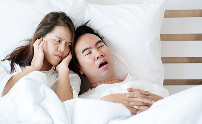 Couple,On,Bed,With,White,Mattress,Man,Snoring,Loud,Makes