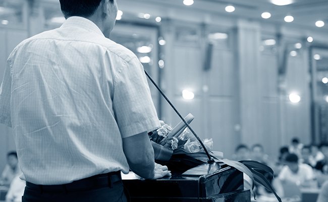 Business,Man,Is,Making,A,Speech,In,Front,Of,A