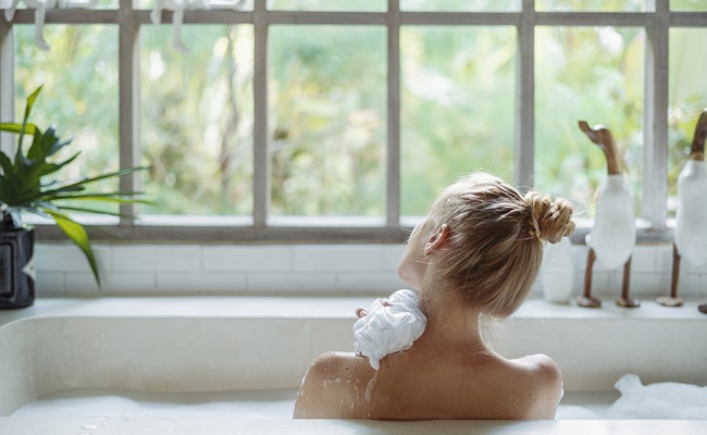 Skin,Care,Concept.,Back,View,Of,Young,Adult,Woman,Taking