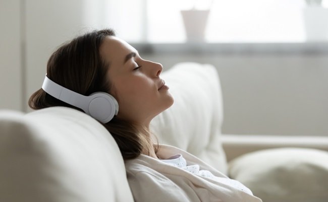 Peaceful,Girl,In,Modern,Wireless,Headphones,Sit,Relax,On,Comfortable