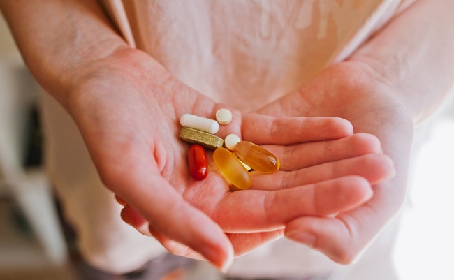 A,Handful,Of,Multi-colored,Tablets,Or,Vitamins,In,The,Palm