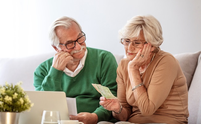 Senior,Couple,At,Home,With,Many,Bills.,Dman,And,Woman