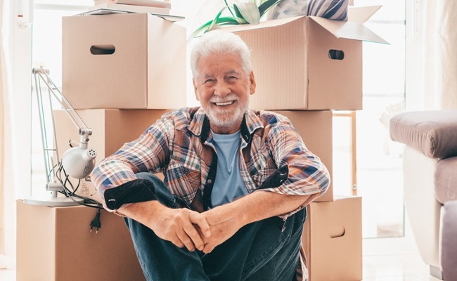 Happy,Senior,Man,Sitting,On,Floor,Relaxing,In,New,Home