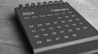 Black,And,White,February,2024,Desk,Calendar,On,Wooden,Desk.