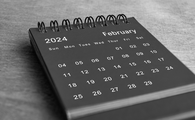 Black,And,White,February,2024,Desk,Calendar,On,Wooden,Desk.