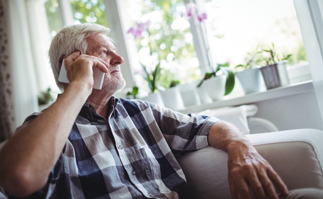 Senior,Man,Talking,On,Mobile,Phone,At,Home