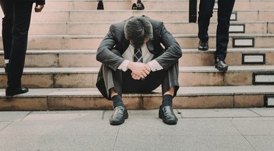 Depressed,And,Tired,Businessman,Sitting,At,Stair,In,City