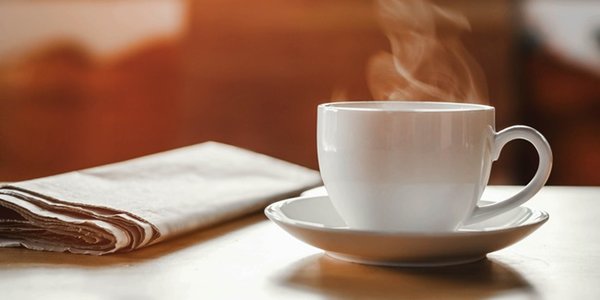 Coffee,Cup,With,Newspaper,On,The,Table,,Coffee,Shop,Background,