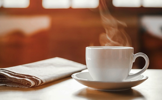 Coffee,Cup,With,Newspaper,On,The,Table,,Coffee,Shop,Background,