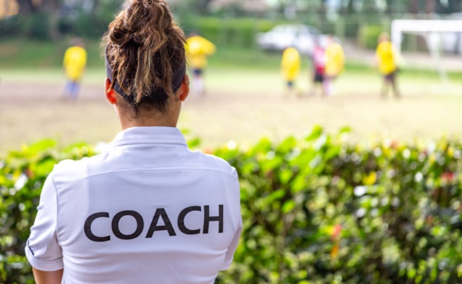 Back,View,Of,A,Female,Soccer,,Football,,Coach,In,White