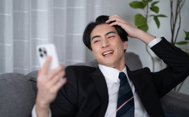 A,Japanese,Businessman,Sitting,On,A,Sofa.,Scene,Where,He