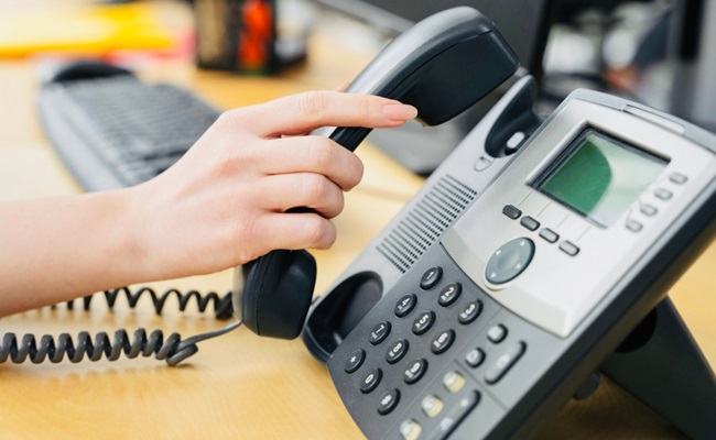 A,Woman,Is,Holding,Phone,Receiver.