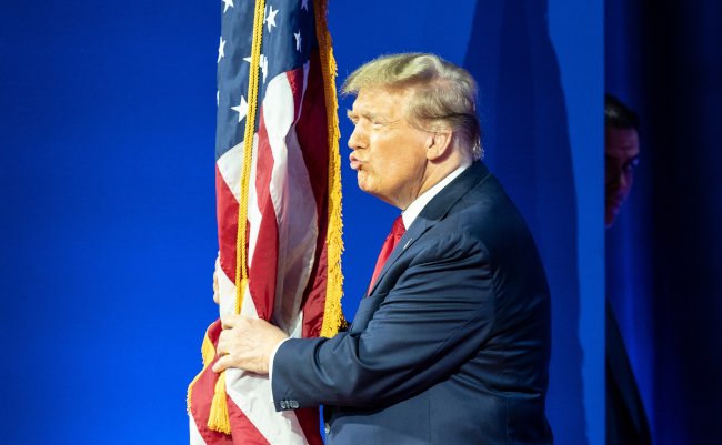 Former,President,Donald,J.,Trump,Kisses,American,Flag,At,Arriving