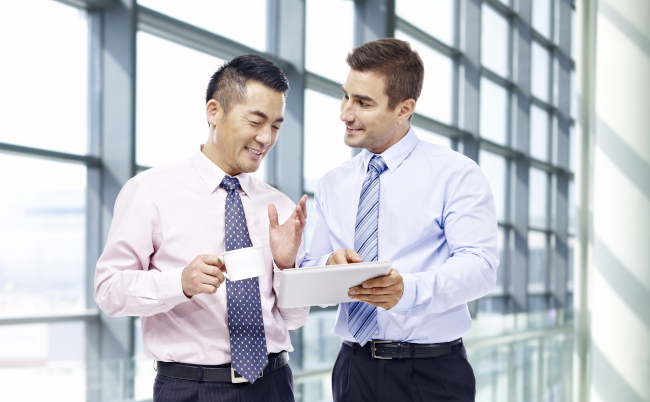 Two,Businessmen,,One,Asian,And,One,Caucasian,,Having,A,Discussion