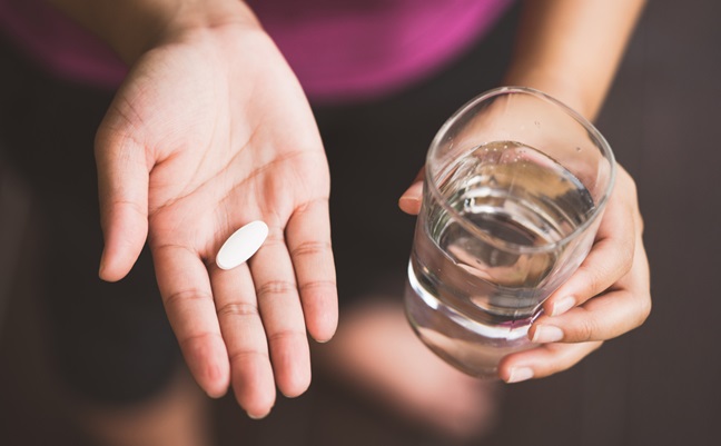 Close,Up,Of,Girl,Holding,Pill,And,Glass,Of,Water.with