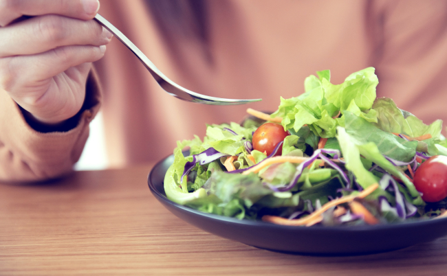 Closeup,Woman,Eating,Healthy,Food,Salad,,Focus,On,Salad,And