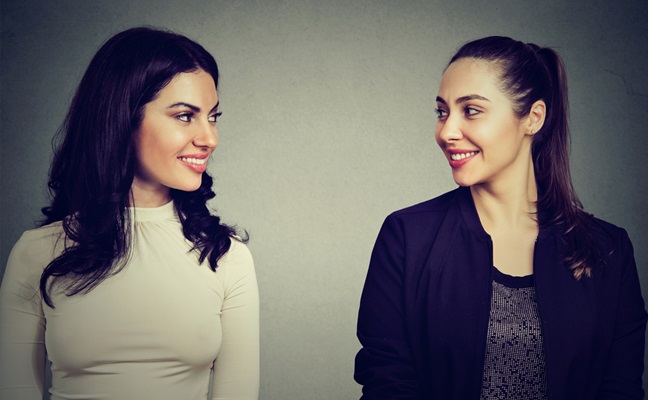 Portrait,Of,Two,Happy,Young,Women,Looking,At,Each,Other